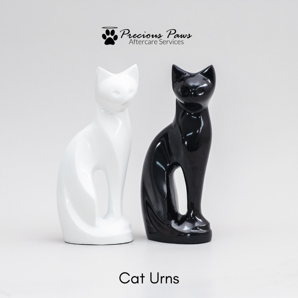 White and black stylized cat urns