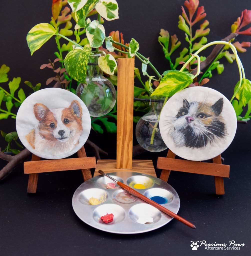 Hand-painted marble urn lids with cat and dog portraits on easels
